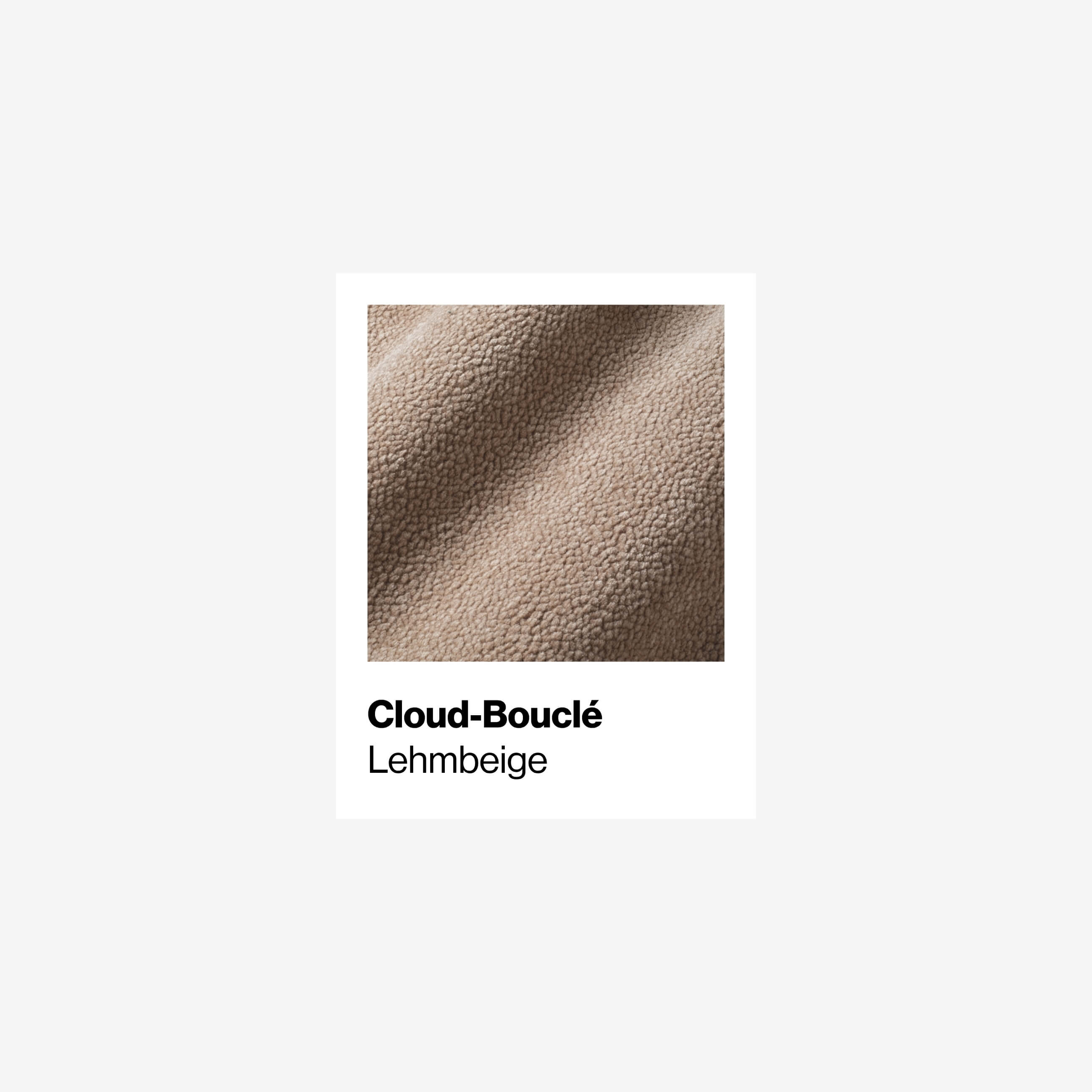 Nahaufnahme eines strukturierten, beigen Stoffes mit der Aufschrift "Cloud-Bouclé" in fetter Schrift und "Lehmbeige" darunter auf weißem Hintergrund. Der Stoff hat ein weiches, leicht gewelltes Aussehen.