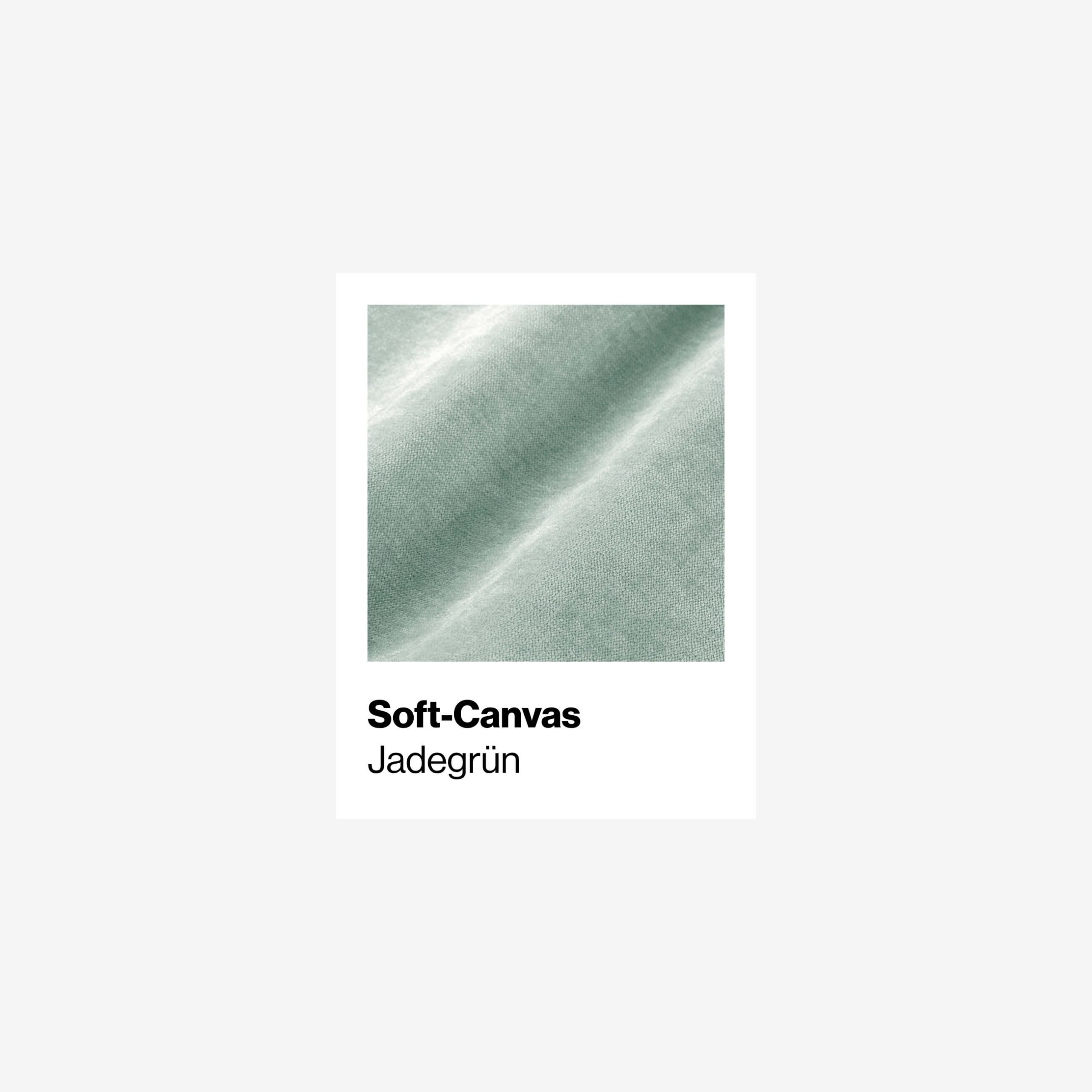 Eine Nahaufnahme von Soft-Canvas-Gewebe in einer hellen jadegrünen Farbe, mit sichtbarer Textur und sanften Falten. Der Text darunter lautet Soft-Canvas Jadegrün.